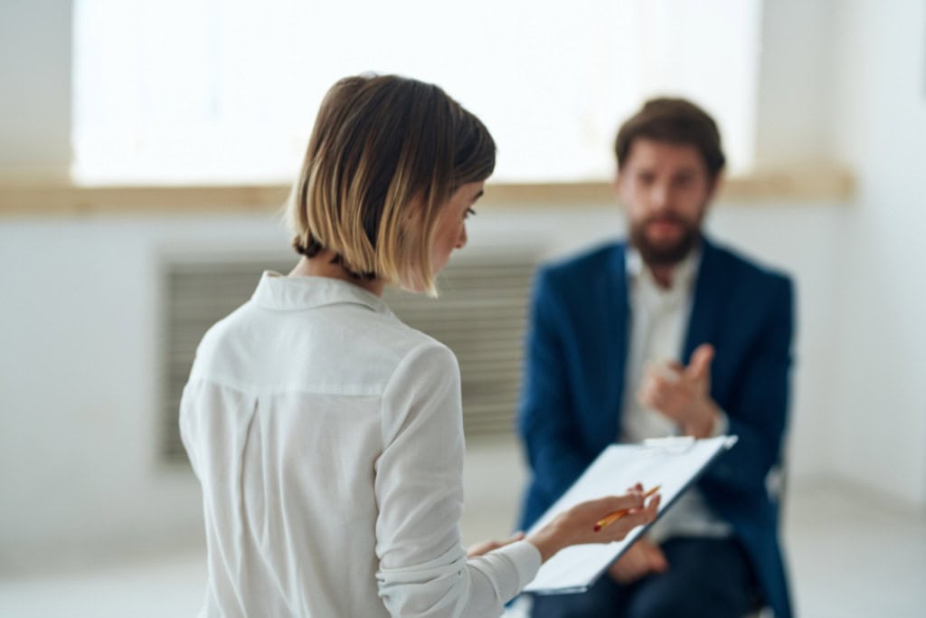 A professional therapist discusses treatment options with a patient in a session, highlighting dual diagnosis treatment in Reseda CA.