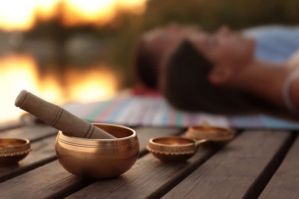 A serene setup with a Tibetan singing bowl, used in holistic therapy sessions in Reseda CA for relaxation and mindfulness practices.