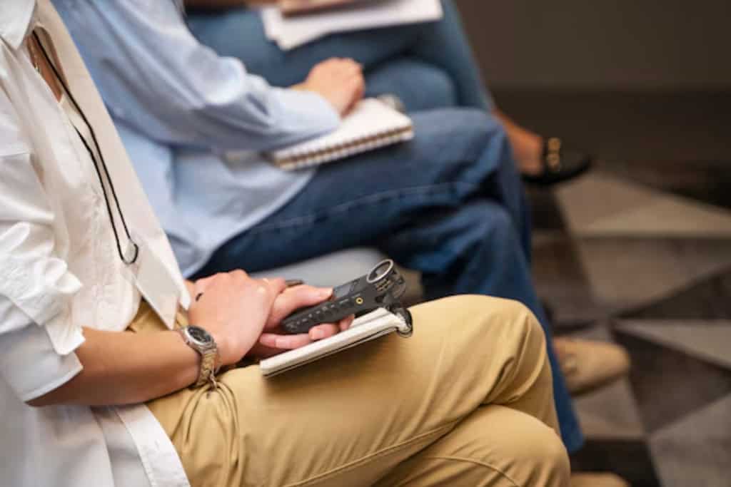 Close-up of a group therapy meeting, part of a 12-step addiction recovery program in Reseda, CA, where members find support and encouragement.
