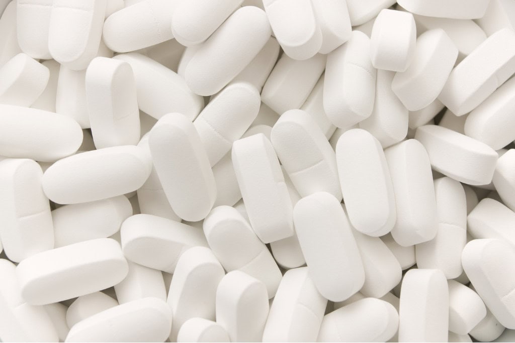 A close-up image of white tablets scattered, symbolizing the prescription medications associated with potential misuse. This highlights the need for Xanax addiction treatment in Reseda CA to address dependency issues.