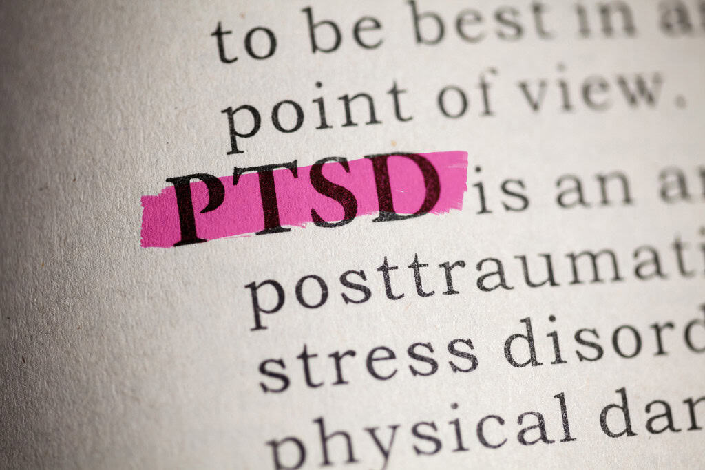 Highlighted text of 'PTSD' in a dictionary, symbolizing the importance of PTSD treatment in Reseda CA for mental health recovery.