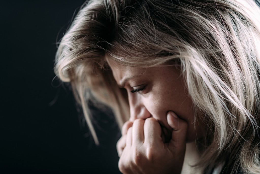 A distressed woman experiencing PTSD symptoms, illustrating the need for effective PTSD treatment in Reseda CA."