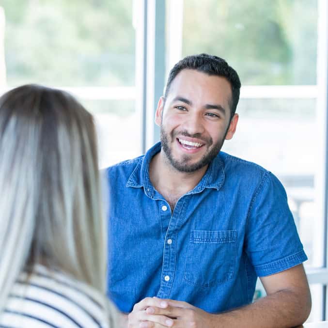 A man smiles while engaged in addiction counseling in Reseda, CA, creating a supportive and positive environment for recovery and personal growth.