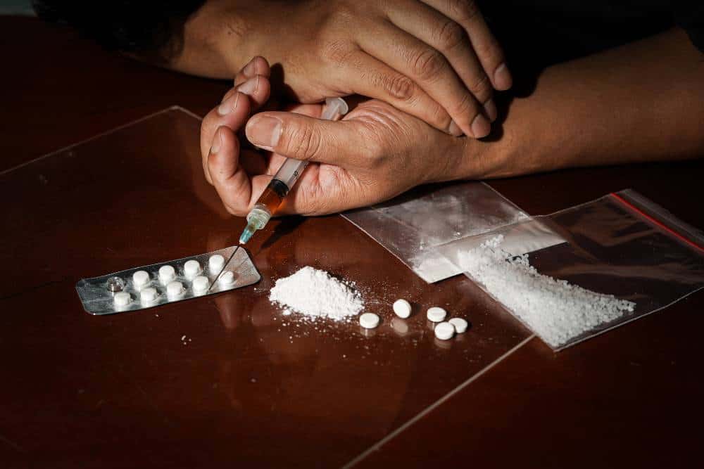 Drug paraphernalia and white powder representing substance abuse before starting cocaine detox in Reseda CA.