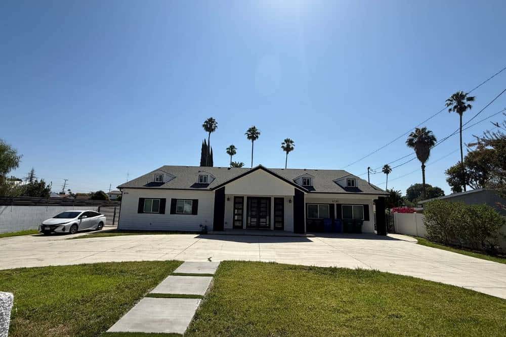 Luxury residential-style inpatient rehab facility in Reseda, CA with gated driveway, modern exterior, and peaceful surroundings.